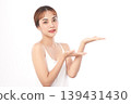 A beautiful young Asian woman with clean, fresh skin against a white background. Skincare, facial treatment, cosmetology, beauty, and spa. An elegant portrait of an Asian woman. 139431430