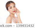 A beautiful young Asian woman with clean, fresh skin against a white background. Skincare, facial treatment, cosmetology, beauty, and spa. An elegant portrait of an Asian woman. 139431432