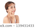 A beautiful young Asian woman with clean, fresh skin against a white background. Skincare, facial treatment, cosmetology, beauty, and spa. An elegant portrait of an Asian woman. 139431433