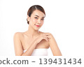 A beautiful young Asian woman with clean, fresh skin against a white background. Skincare, facial treatment, cosmetology, beauty, and spa. An elegant portrait of an Asian woman. 139431434