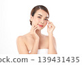A beautiful young Asian woman with clean, fresh skin against a white background. Skincare, facial treatment, cosmetology, beauty, and spa. An elegant portrait of an Asian woman. 139431435