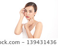 A beautiful young Asian woman with clean, fresh skin against a white background. Skincare, facial treatment, cosmetology, beauty, and spa. An elegant portrait of an Asian woman. 139431436
