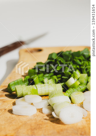 Freshly chopped green onions on a wooden cutting board Freshly chopped green onions on a wooden cutting board 139431654