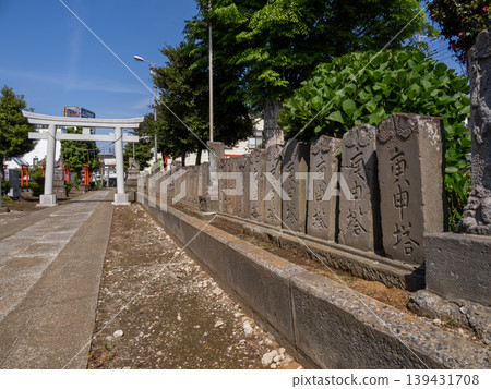 A path lined with 100 Koshin stone monuments: A scene of Koshin worship amidst a residential area - Kamagaya Hachiman Shrine 139431708
