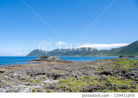 Lanyu, Taiwan: Panoramic view of the volcanic rock coastline, overlooking the mountains and the Pacific Ocean. Lanyu, Taiwan: Panoramic view of the volcanic rock coastline, overlooking the mountains and the Pacific Ocean. 139431856