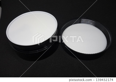 White Cosmetic Containers on Black Background White Cosmetic Containers on Black Background 139432174