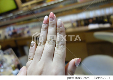 Hand with Glitter Nail Art in Salon Setting Hand with Glitter Nail Art in Salon Setting 139432205