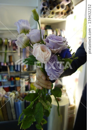 Hand Holding Floral Bouquet in Craft Store Hand Holding Floral Bouquet in Craft Store 139432252
