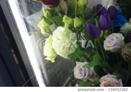 Fresh Floral Bouquet with Roses and Tulips Near Window 139432262