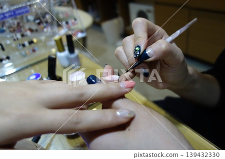 Nail Artist Applying Decorative Nail Art Nail Artist Applying Decorative Nail Art 139432330