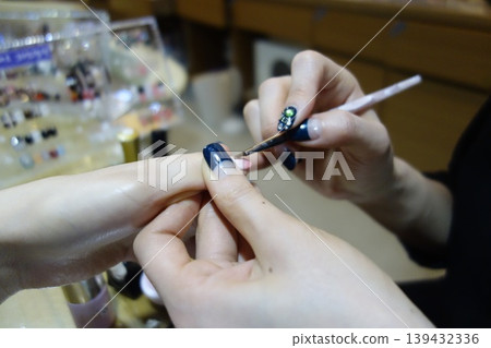 Nail Artist Applying Blue Polish to Client's Nail Nail Artist Applying Blue Polish to Client's Nail 139432336
