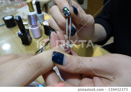 Nail Artist Applying Decorative Nail Art Nail Artist Applying Decorative Nail Art 139432373