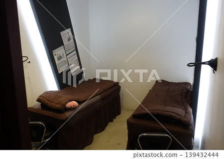 Small Dormitory Room with Two Beds and Information Posters 139432444
