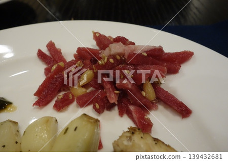 Watermelon and Garlic Garnish on White Plate 139432681