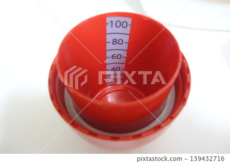 Red Measuring Cup with Graduations 139432716