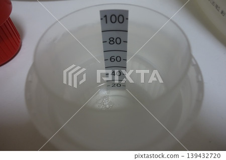 Measuring Cup with Water Level 139432720