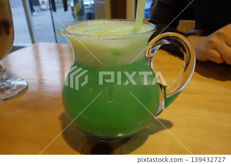 Green Iced Beverage in Glass Pitcher with Straw Green Iced Beverage in Glass Pitcher with Straw 139432727
