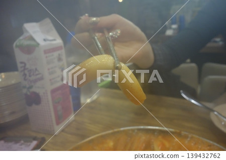 Tongs Holding Steamed Food Over Hot Pot Tongs Holding Steamed Food Over Hot Pot 139432762