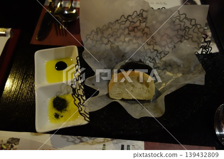 Bread with Olive Oil and Condiments on Table Bread with Olive Oil and Condiments on Table 139432809
