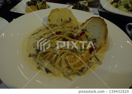 Creamy Pasta Dish with Bread and Garnishes Creamy Pasta Dish with Bread and Garnishes 139432820