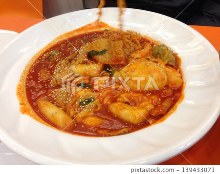 Spicy Korean Tteokbokki with Sesame Seeds and Noodles Spicy Korean Tteokbokki with Sesame Seeds and Noodles 139433071