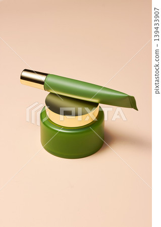 Luxury Cosmetic Tube Balanced on Green Jar Luxury Cosmetic Tube Balanced on Green Jar 139433907