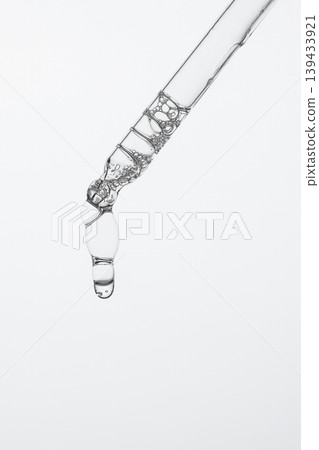 Clear Cosmetic Serum Hanging From Pipette Clear Cosmetic Serum Hanging From Pipette 139433921