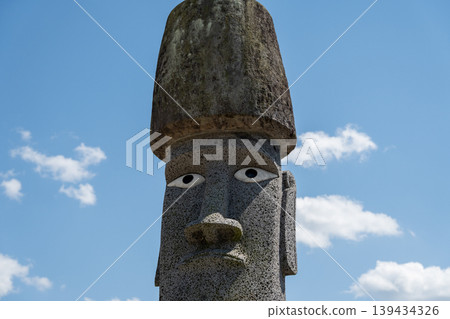 A scene of the Minamisanriku Moai statues, imbued with prayers for recovery from the earthquake, against a blue sky. A scene of the Minamisanriku Moai statues, imbued with prayers for recovery from the earthquake, against a blue sky. 139434326