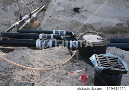 Underground insulated utility pipe junctions in trench for district heating construction project Underground insulated utility pipe junctions in trench for district heating construction project 139434351
