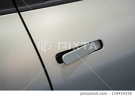 Flush car door handle detail on modern vehicle with sleek minimal automotive exterior design Flush car door handle detail on modern vehicle with sleek minimal automotive exterior design 139434356