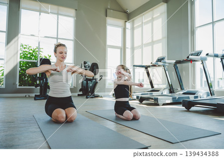 Mother and Daughter Practicing Yoga Together with Grace Mother and Daughter Practicing Yoga Together with Grace 139434388