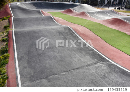 Outdoor red and black pump track at a skatepark for biking, skating and urban sports Outdoor red and black pump track at a skatepark for biking, skating and urban sports 139435319