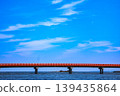 A crimson boundary line separates the sky and the sea. A single-lane bridge with a striking, vivid contrast. 139435864