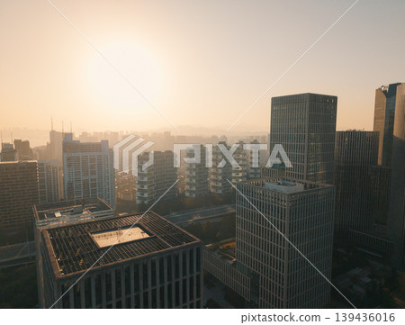 Downtown buildings and skyscrapers in Hangzhou at early evening, sunlight reflecting off windows, showing modern architecture Downtown buildings and skyscrapers in Hangzhou at early evening, sunlight reflecting off windows, showing modern architecture 139436016