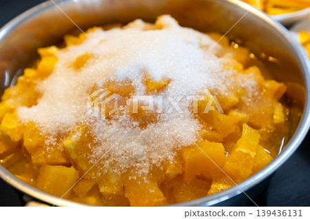 chopped orange pulp topped with white sugar chopped orange pulp topped with white sugar 139436131