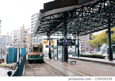 A streetcar stopping at Yokogawa Station on the Hiroshima Electric Railway Yokogawa Line. A streetcar stopping at Yokogawa Station on the Hiroshima Electric Railway Yokogawa Line. 139436356
