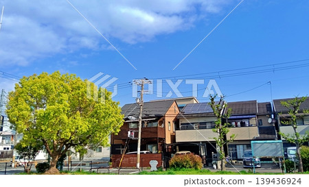 A beautiful spring scene of a residential area and streetscape with a blue sky and fresh greenery. A beautiful spring scene of a residential area and streetscape with a blue sky and fresh greenery. 139436924