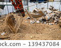 Construction industry image: excavator arm and rubble of demolished building. 139437084