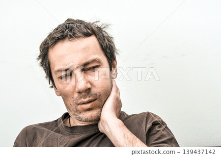 Young man suffering from toothache pain Young man suffering from toothache pain 139437142