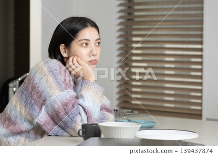 A lifestyle image of a young woman relaxing at home. A lifestyle image of a young woman relaxing at home. 139437874
