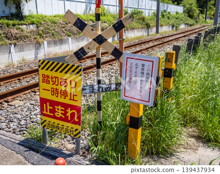 Warning signs and tracks at a level crossing without warning signals: An example of traffic infrastructure that encourages safety checks. Warning signs and tracks at a level crossing without warning signals: An example of traffic infrastructure that encourages safety checks. 139437934