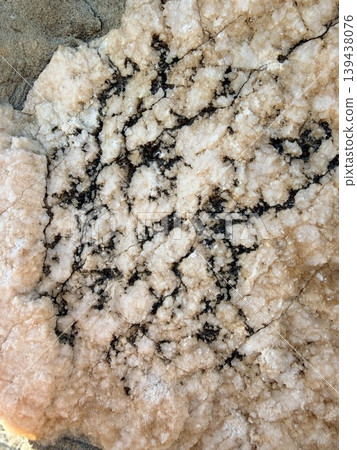 high-angle view of a textured rock surface, likely a section of granite or a similar igneous or metamorphic formation. high-angle view of a textured rock surface, likely a section of granite or a similar igneous or metamorphic formation. 139438076