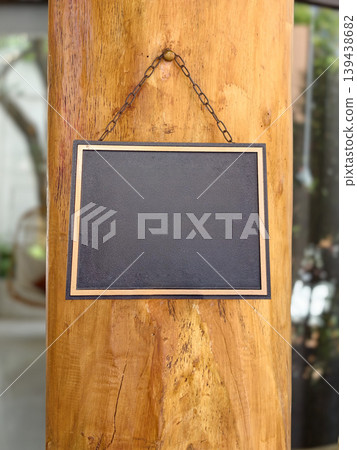 A blank sign hanging on a wooden post 139438682