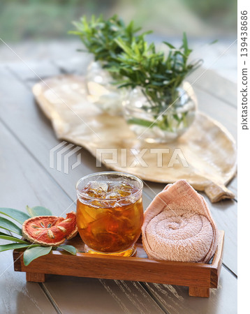 Bael fruit juice serving with cold towel Bael fruit juice serving with cold towel 139438686
