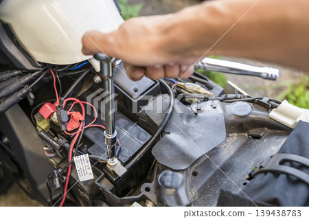 Motorcycle battery replacement maintenance work Motorcycle battery replacement maintenance work 139438783