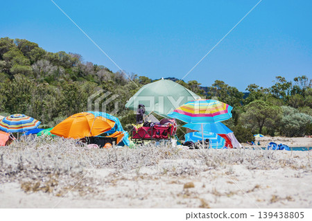 Colorful Beach Umbrellas on Sandy Shore Summer Vacation Scene on Sardinia, Italy Colorful Beach Umbrellas on Sandy Shore Summer Vacation Scene on Sardinia, Italy 139438805