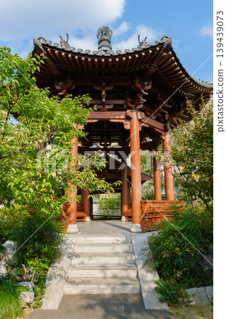 Wooden Chinese pavilion with a traditional curved roof and stone steps surrounded by lush greenery in Hangzhou Wooden Chinese pavilion with a traditional curved roof and stone steps surrounded by lush greenery in Hangzhou 139439073