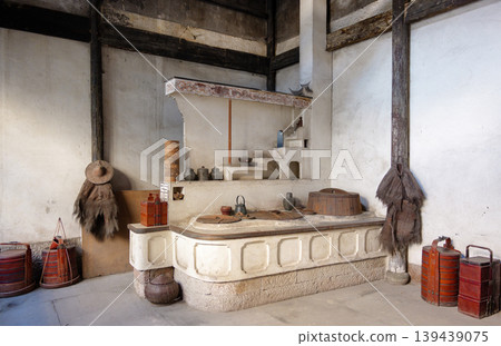 Traditional old kitchen showcasing a large hearth, pots, and period items in Deshou Palace in Hangzhou, China 139439075