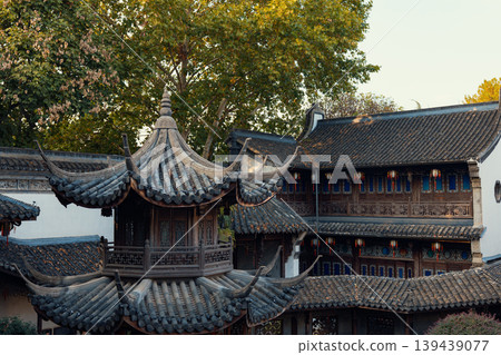 Traditional Chinese architecture showcasing multi-tiered roofs and hanging red lanterns in Hangzhou, China Traditional Chinese architecture showcasing multi-tiered roofs and hanging red lanterns in Hangzhou, China 139439077