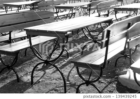 Empty Outdoor Cafe Seating with Vintage Metal and Wood Tables in Black and White Empty Outdoor Cafe Seating with Vintage Metal and Wood Tables in Black and White 139439245